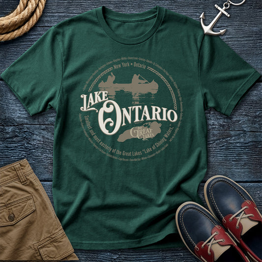 Lake Ontario Great Lakes Blue Spruce tee. New York and Ontario shoreline cities. Canoe and lake outline design on Comfort Colors 1717 garment-dyed cotton. The easternmost lake, fully represented.