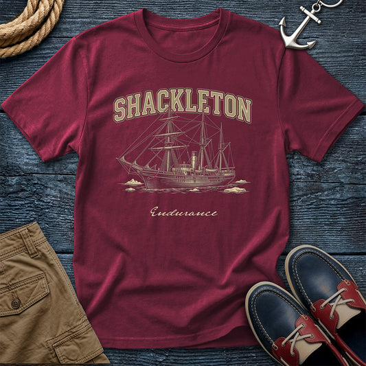 Brick t-shirt with Shackleton and Endurance design on a wooden surface with accessories.