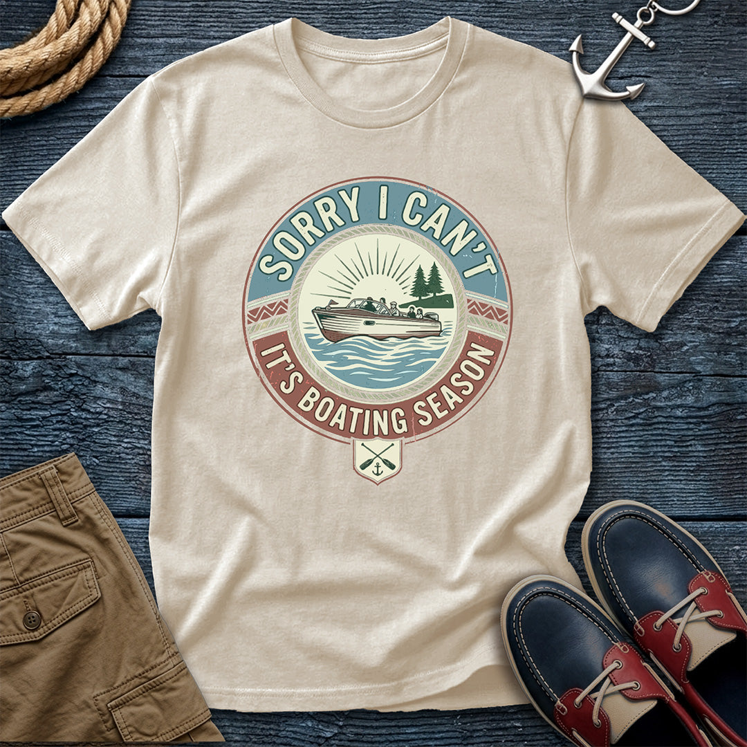 Ivory t-shirt with boating season graphic on a wooden surface with shorts and shoes.