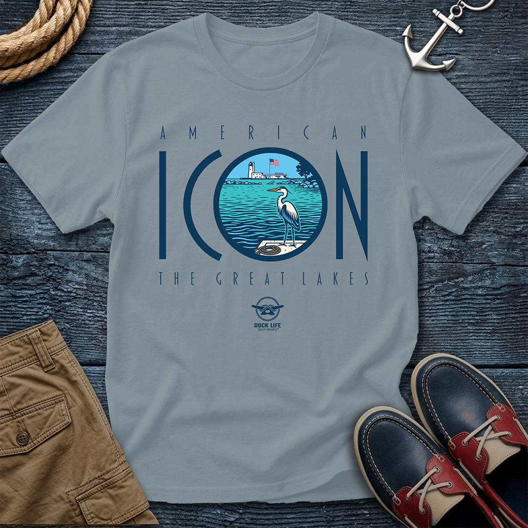 Gray t-shirt with 'American Icon The Great Lakes' design on a wooden surface with shorts and shoes.