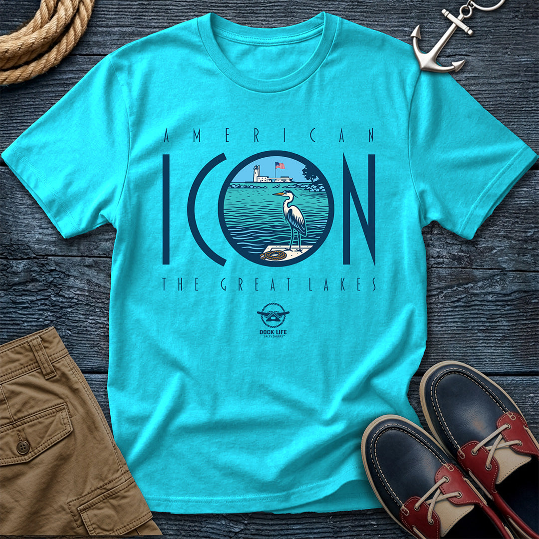 Turquoise t-shirt with 'American Icon The Great Lakes' design on a wooden surface with shorts and shoes.