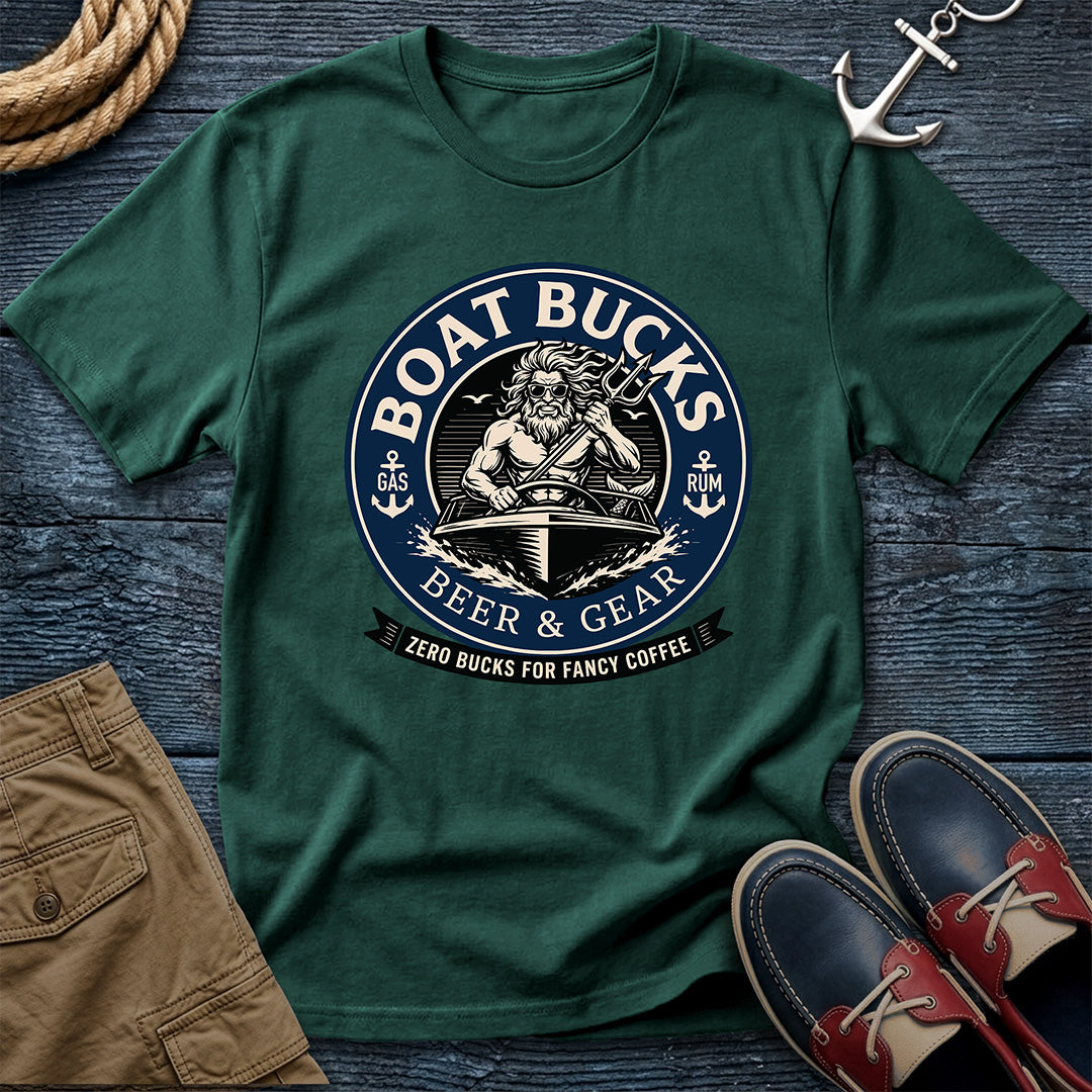 A dark green crewneck t-shirt with a circular 'Boat Bucks Beer & Gear' graphic, styled in a flat lay on a dark wood background with a rope, khaki shorts, an anchor, and boat shoes.