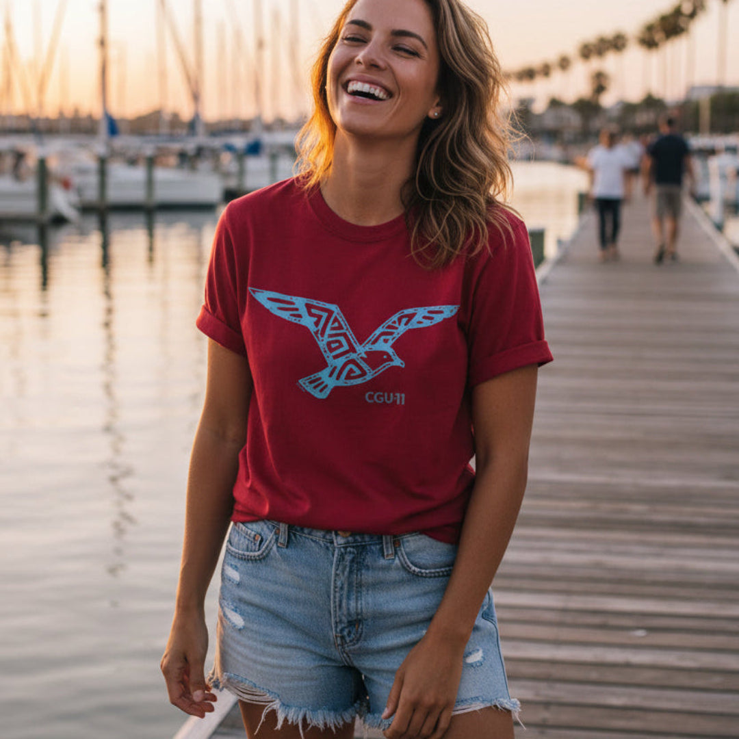 CGU-11 tribal seagull t-shirt in red featuring a flying gull graphic worn by the Capitan's daughter.
