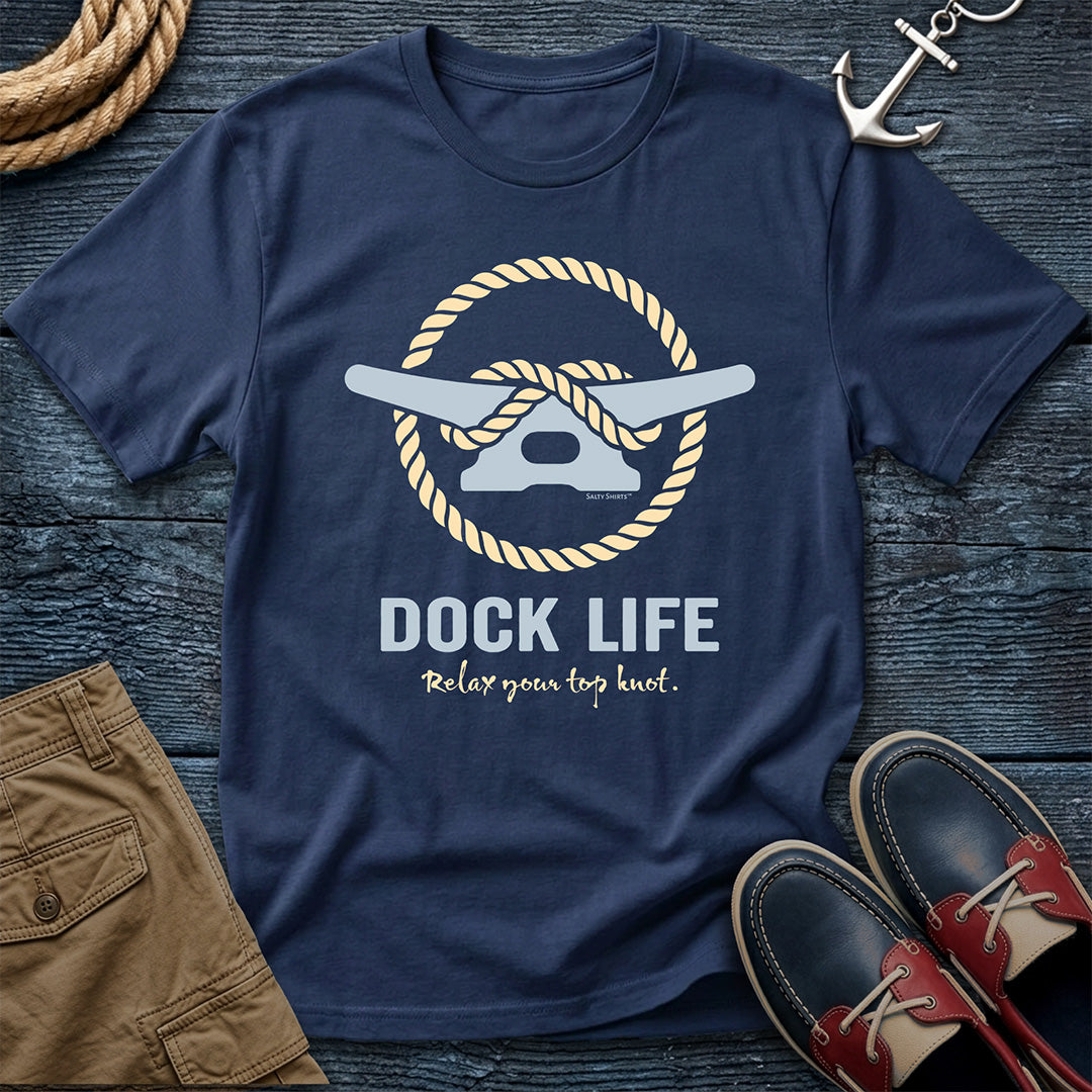 Navy blue t-shirt with 'Dock Life' graphic on a wooden surface with shorts and shoes.