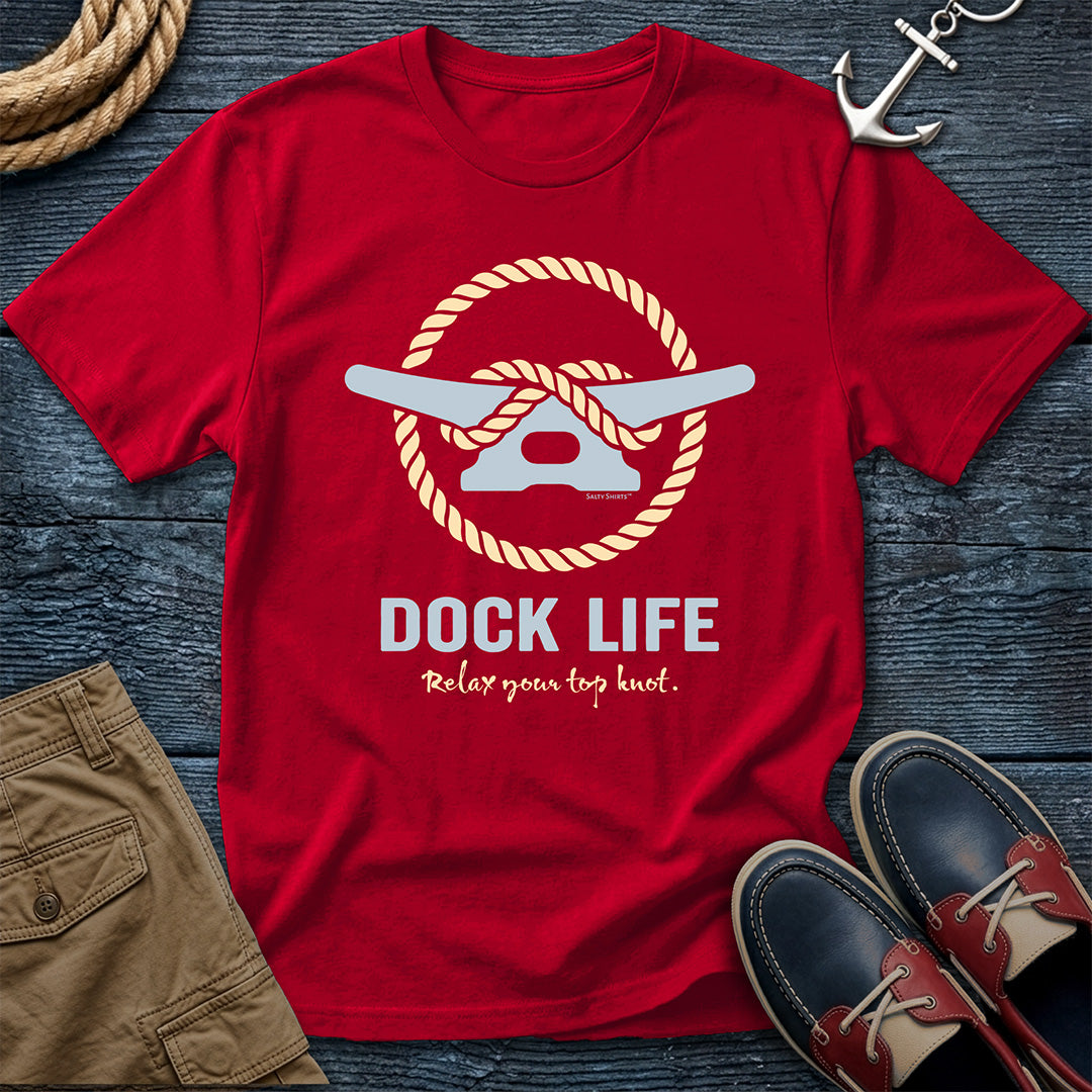 Red t-shirt with 'Dock Life' graphic on a wooden surface with nautical items.