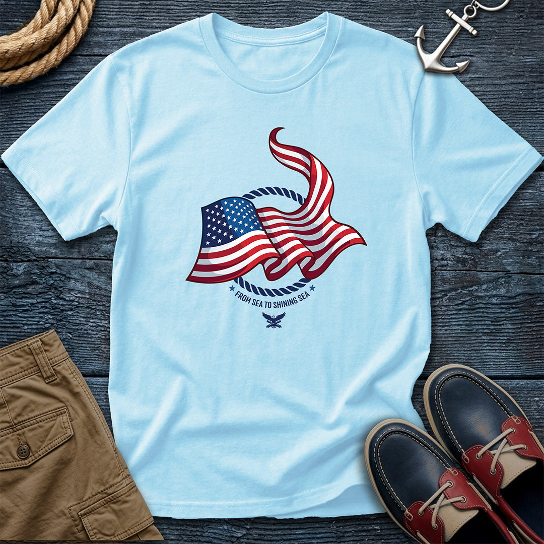 From Sea to Shining Sea American Flag Tee in Chambray, Comfort Colors 1717 garment-dyed shirt with a waving American flag inside a rope ring, curved text, and eagle-and-anchors mark

