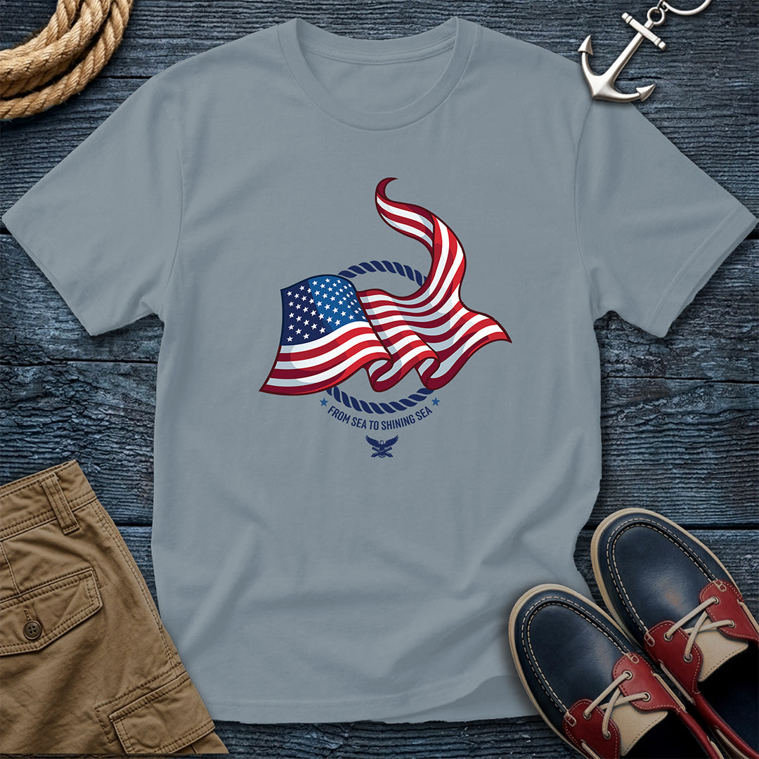From Sea to Shining Sea American Flag Tee in Granite, Comfort Colors 1717 garment-dyed shirt with a waving American flag inside a rope ring, curved text, and eagle-and-anchors mark