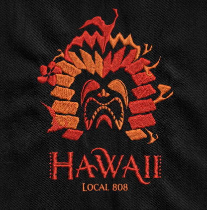 Embroidered Hawaiian tiki design on a black background with 'Hawaii Local 808' text.