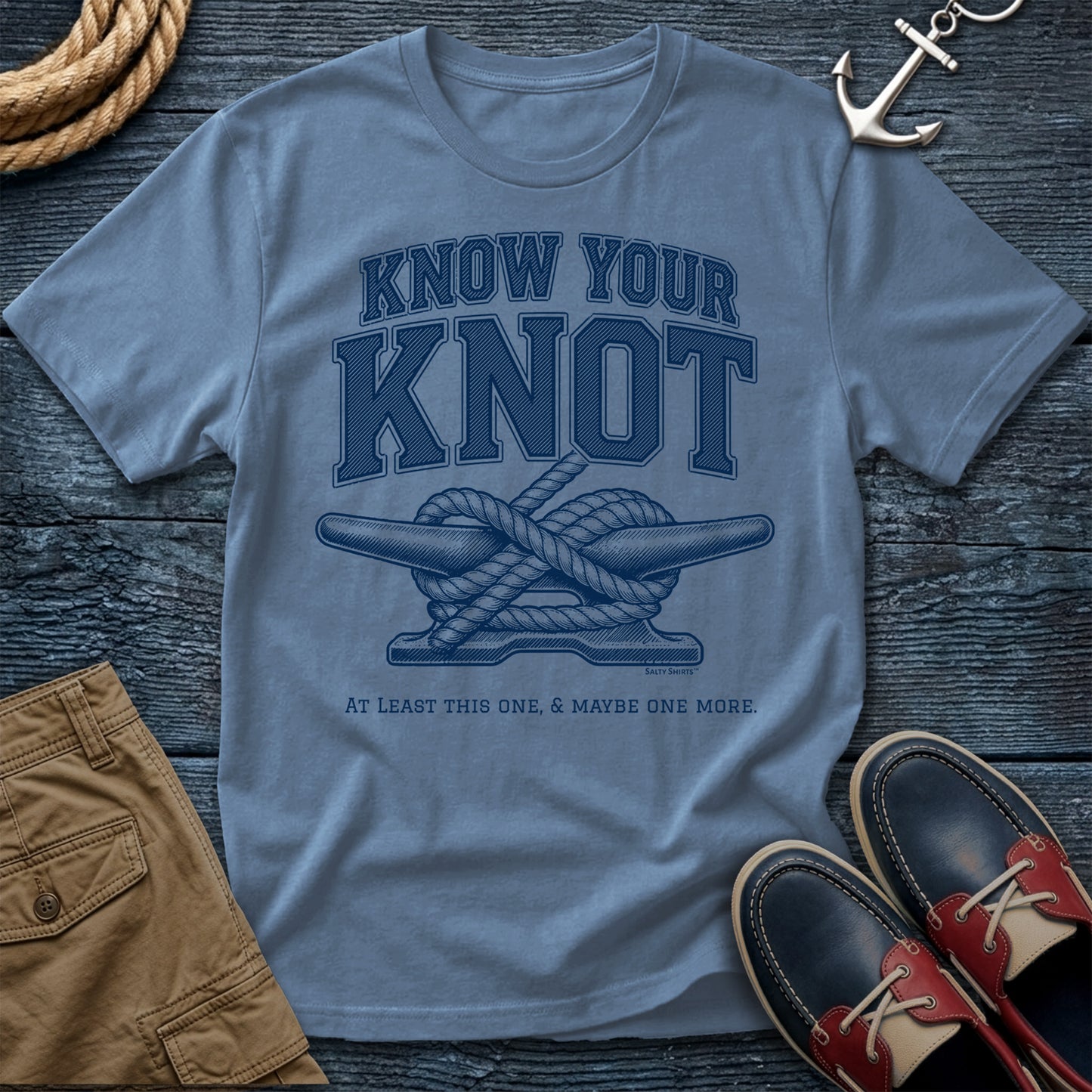Light blue t-shirt with 'Know Your Knot' graphic on a wooden surface with shorts and shoes.