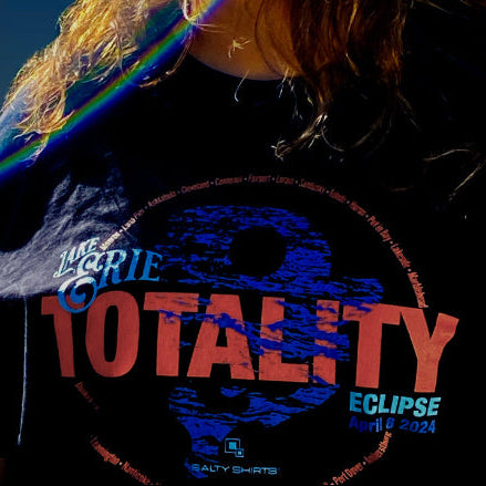 Woman watching eclipse wearing Lake Erie Totality t-shirt