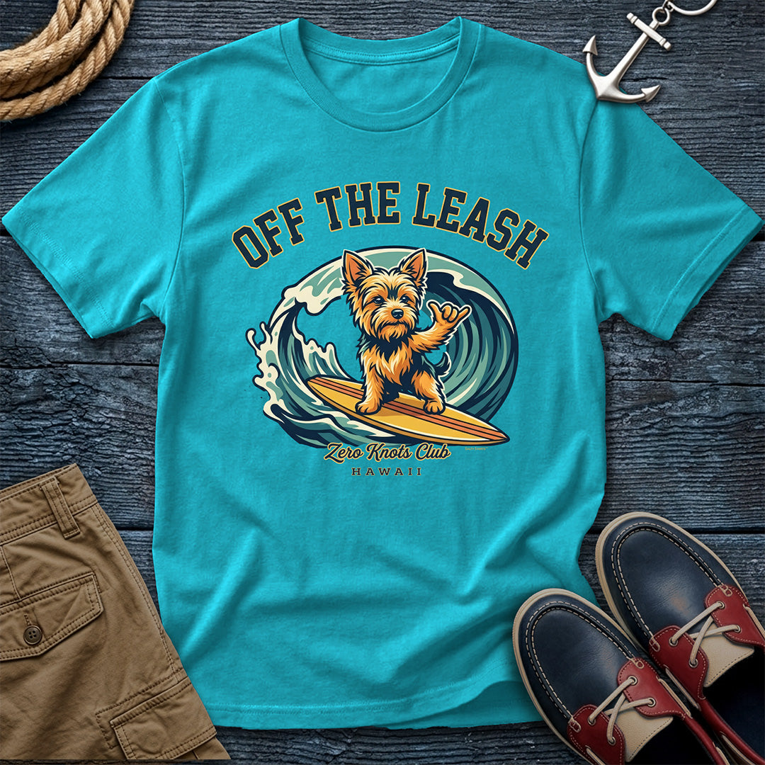 Turquoise t-shirt with a dog graphic and text on a wooden surface with shoes and rope.