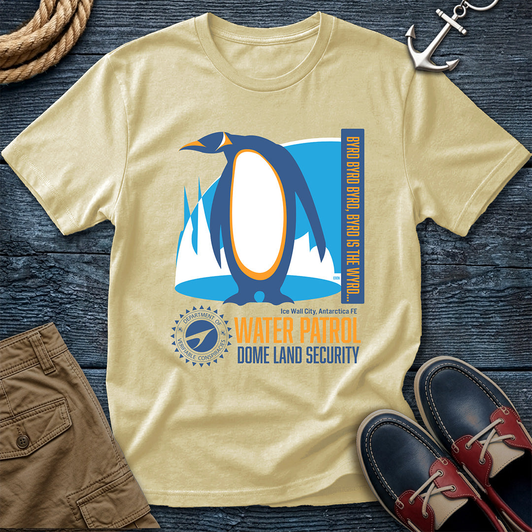 Banana t-shirt with penguin graphic and text on a wooden surface with shorts and shoes.