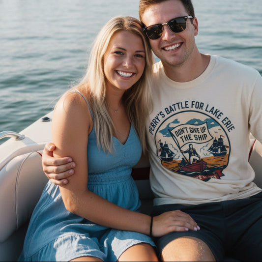 Couple on a boat wearing Perry's Battle of Lake Erie Ivory garment-dyed tee by Salty Shirts