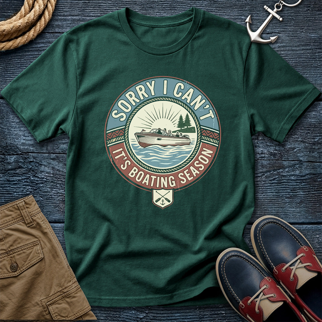 Blue Spruce t-shirt with boating season graphic on a wooden surface with shorts and shoes.