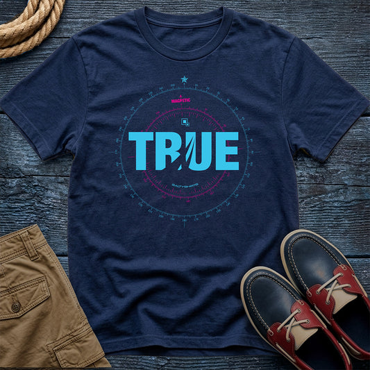 Navy blue t-shirt with 'TRUE' Compass Rose design on a wooden surface with shorts and shoes.