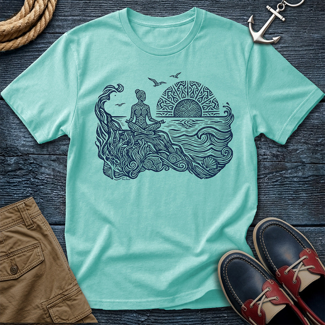 Sunrise Shore Meditation Tee in Chalky Mint, Comfort Colors 1717 garment-dyed shirt with a seated shoreline figure, rising sun, geometric mandala, waves, shells, kelp, and circling gulls.