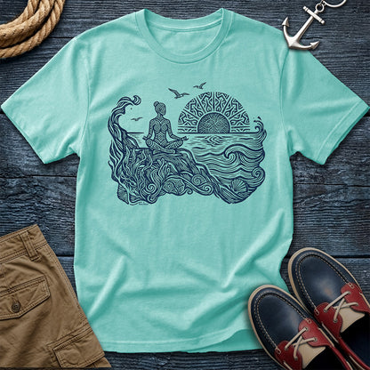 Sunrise Shore Meditation Tee in Chalky Mint, Comfort Colors 1717 garment-dyed shirt with a seated shoreline figure, rising sun, geometric mandala, waves, shells, kelp, and circling gulls.