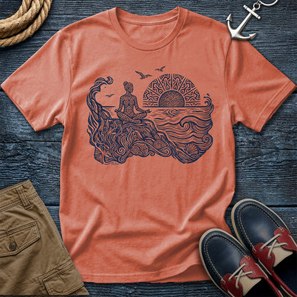 Sunrise Shore Meditation Tee in Terracotta, Comfort Colors 1717 garment-dyed shirt with a seated shoreline figure, rising sun, geometric mandala, waves, shells, kelp, and circling gulls.