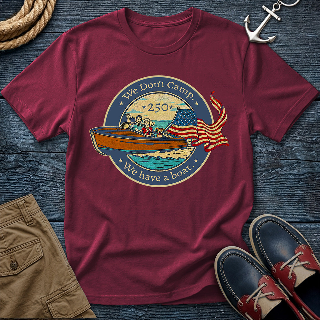 Brick t-shirt with a graphic design of two people in a boat, an American flag, and text on a wooden surface with shorts and shoes.